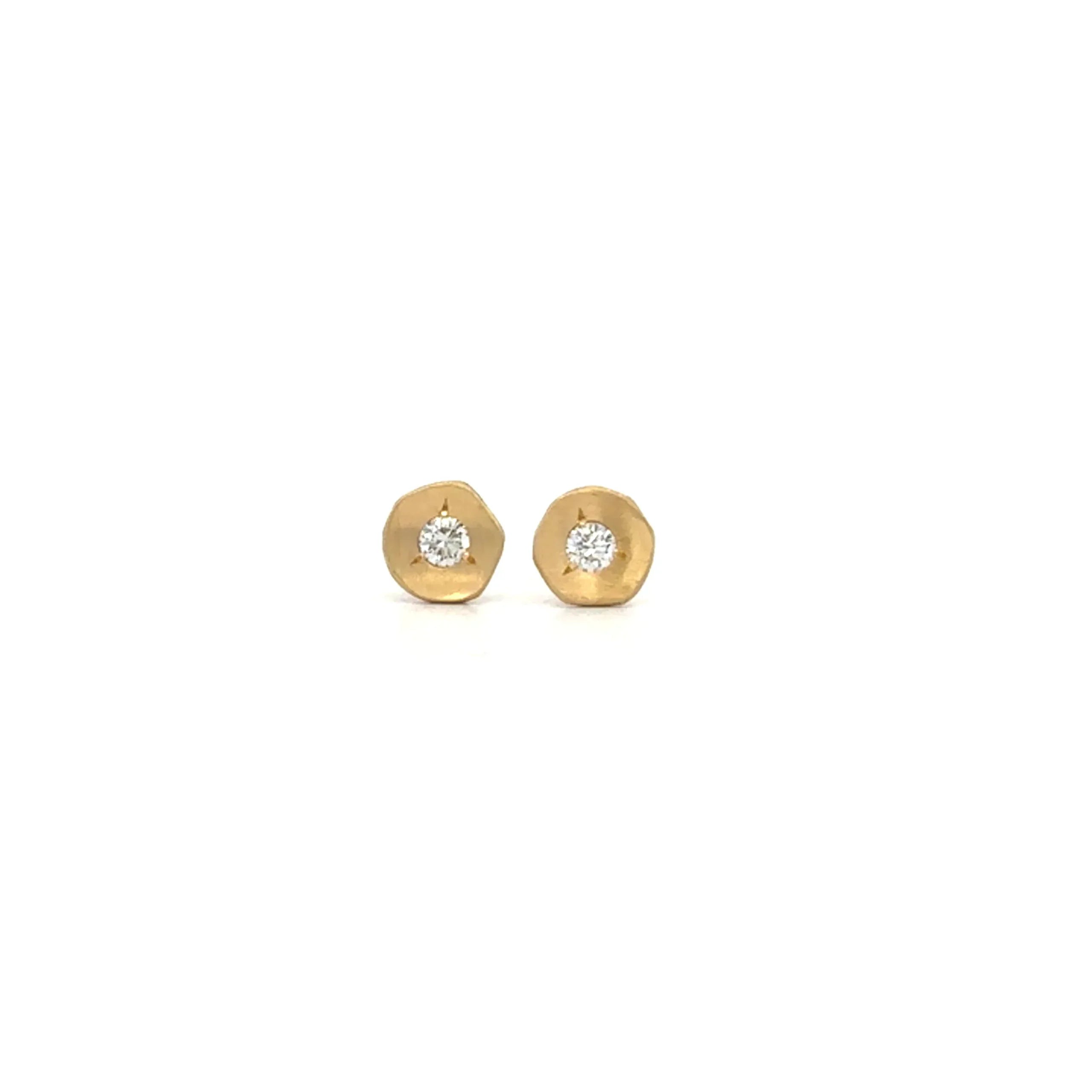 The Ali Dumont Everyday Diamond Stud Earrings feature small, round 18k yellow gold with a hammered texture and a central sparkling diamond, shown against a plain white background.