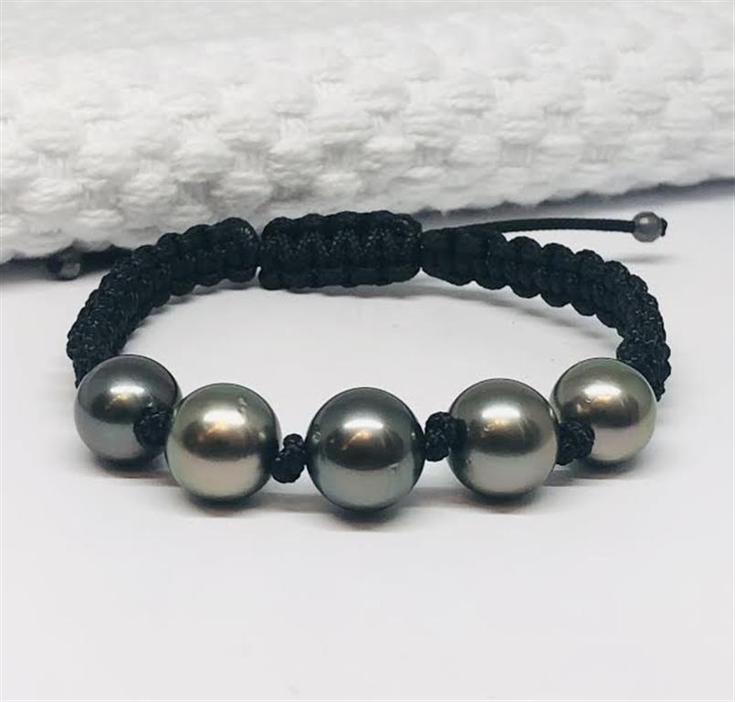 Black cord bracelet with five gray beads on a white background