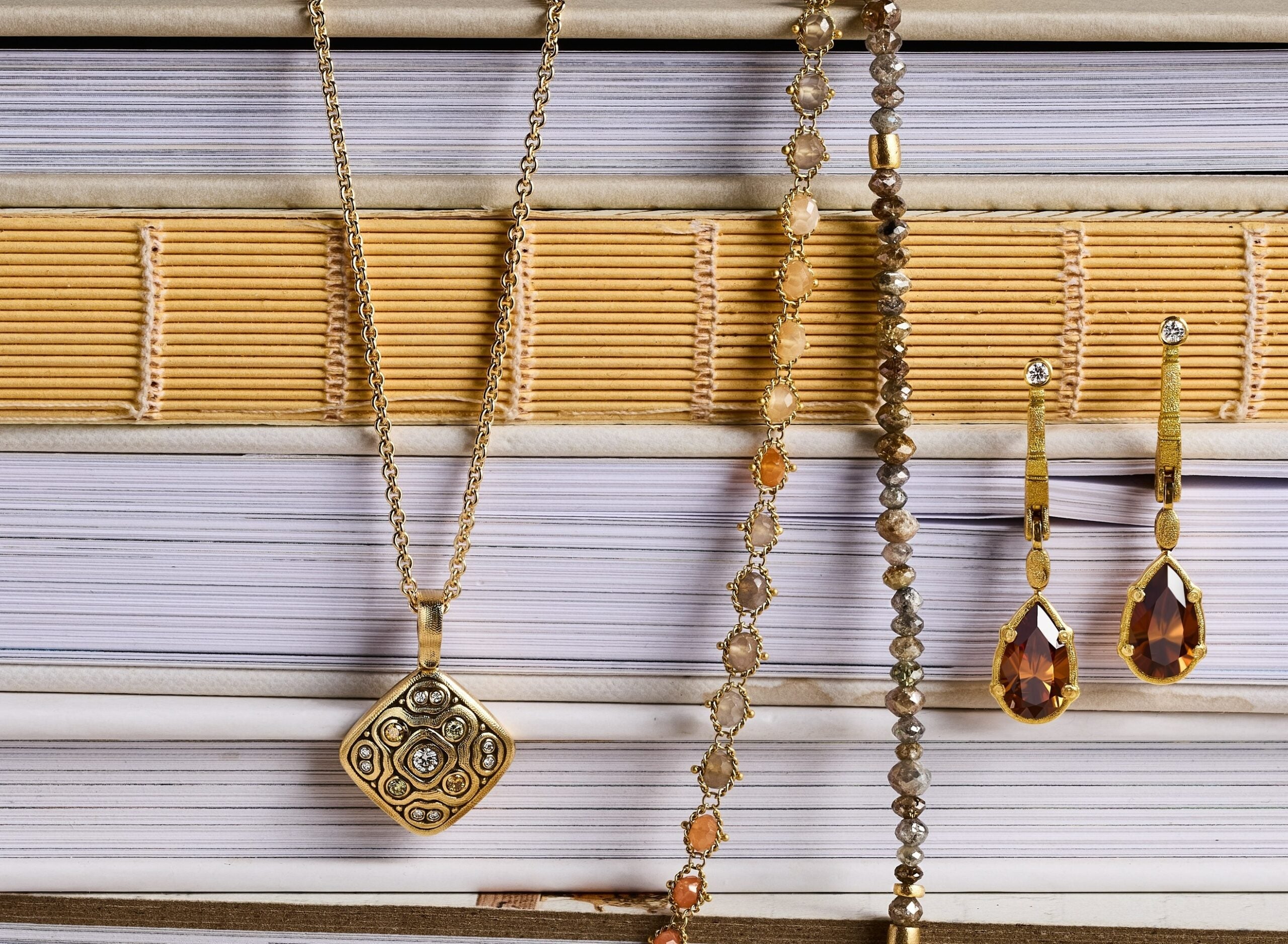 Multiple jewelries displayed on purple and dark yellow background
