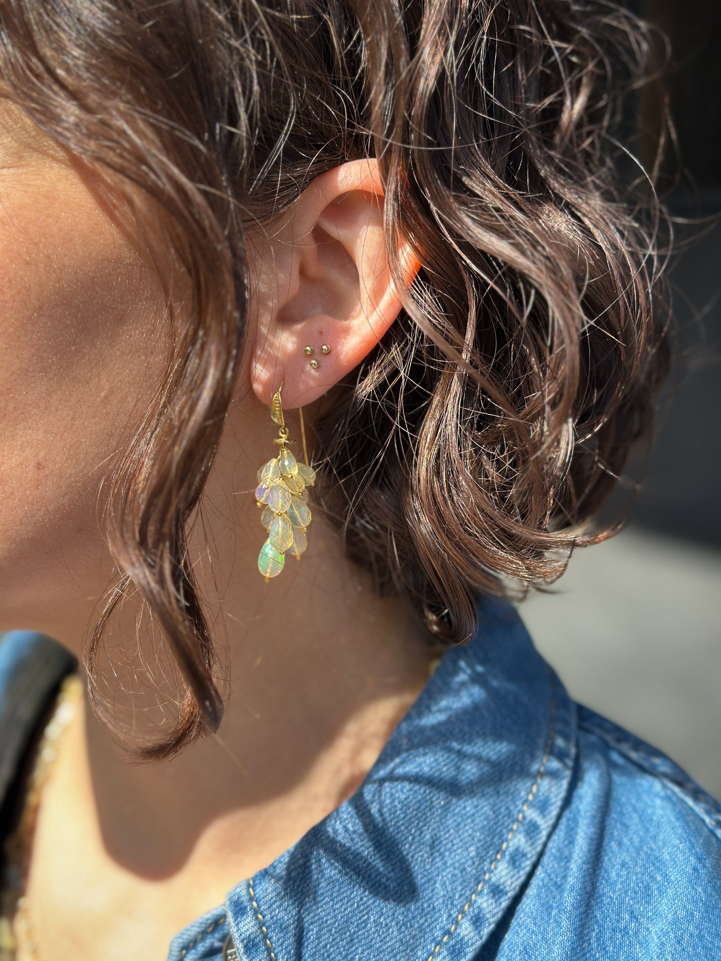 Dark haired woman in a denim shirt wearing Barbara Heinrich Dangling Earrings