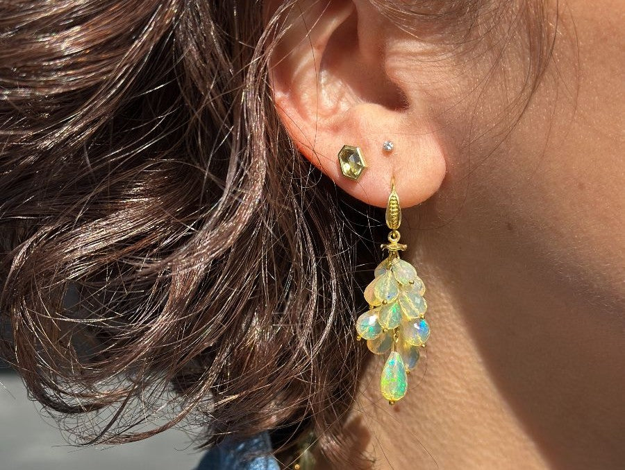 Side profile of a woman wearing elegant gold earrings