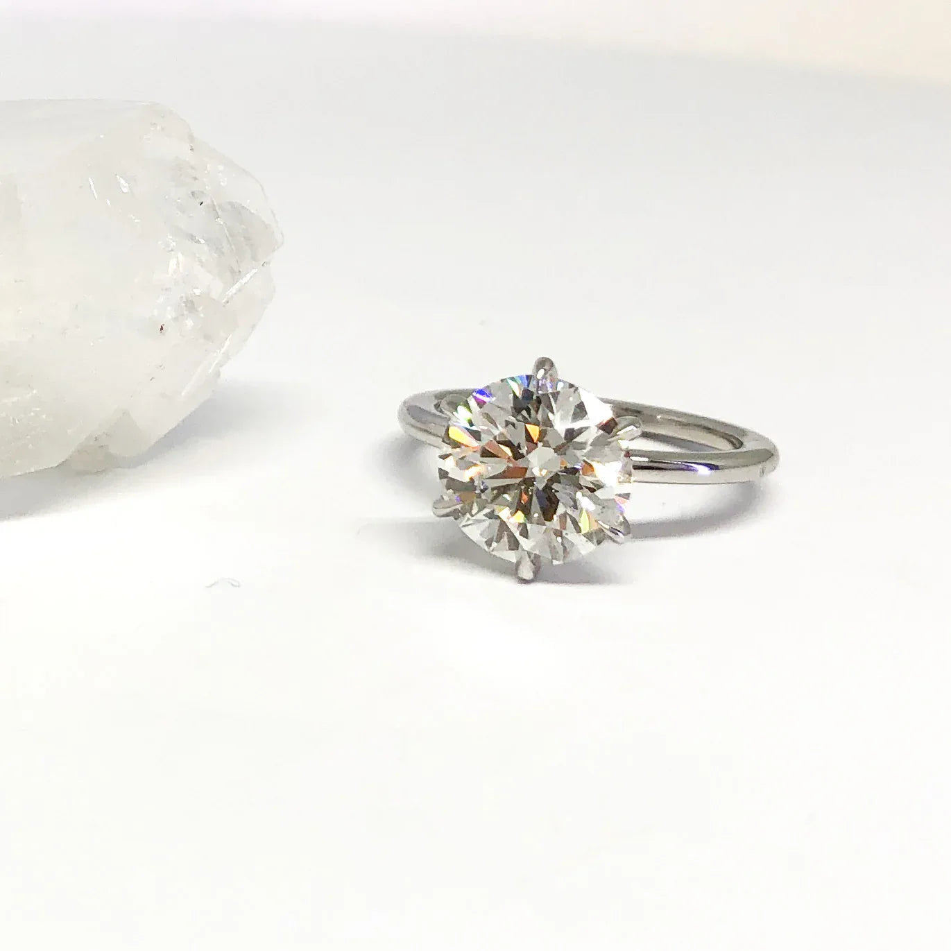 White golden ring on a white surface