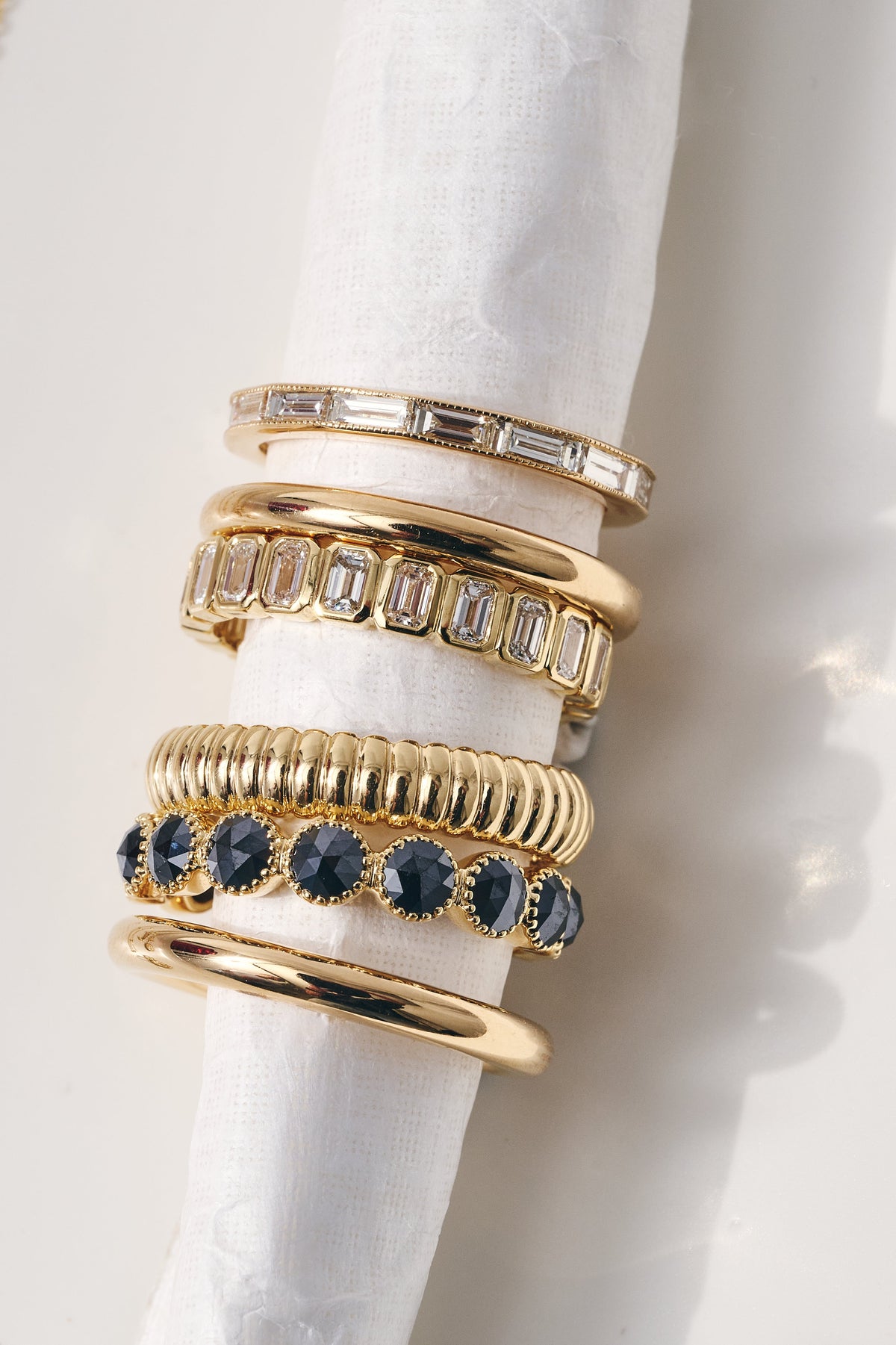 Women's Bands shown together on a white background.  Gold Bands and bands with jewels.
