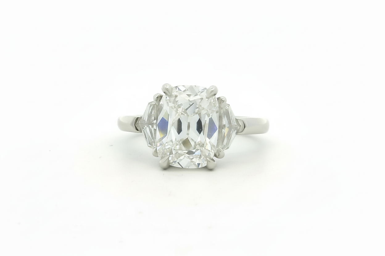 Side stone diamond ring on a white background