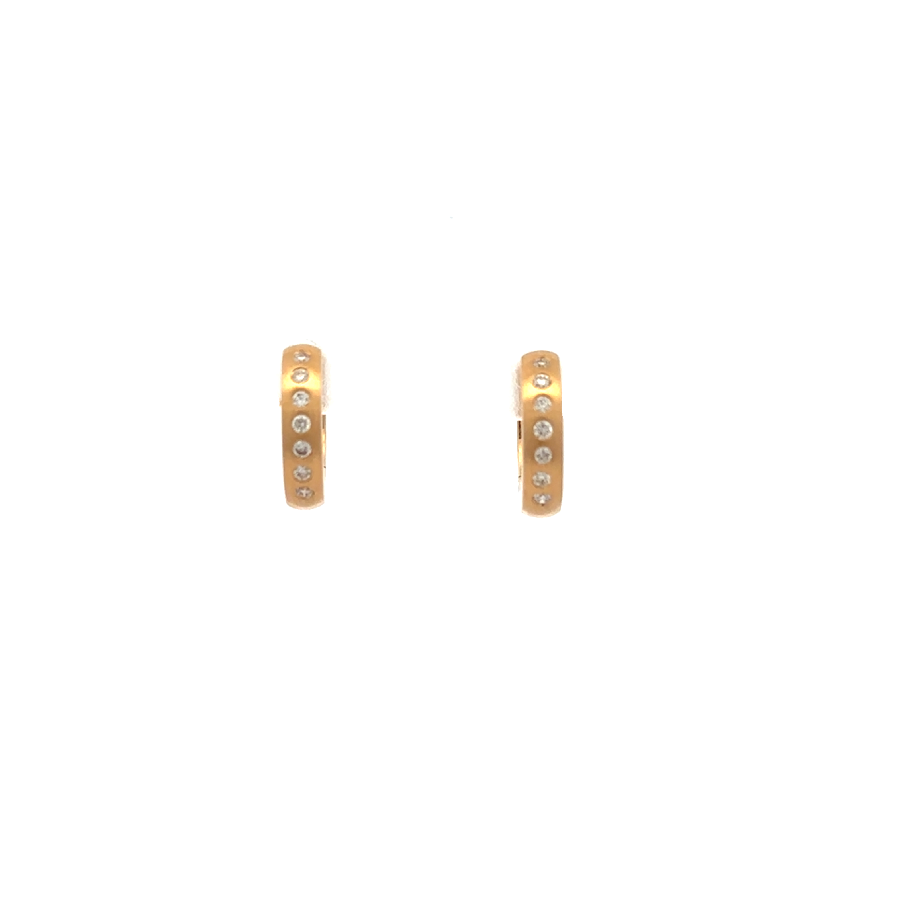 Gold earrings with diamonds embedded on a white background