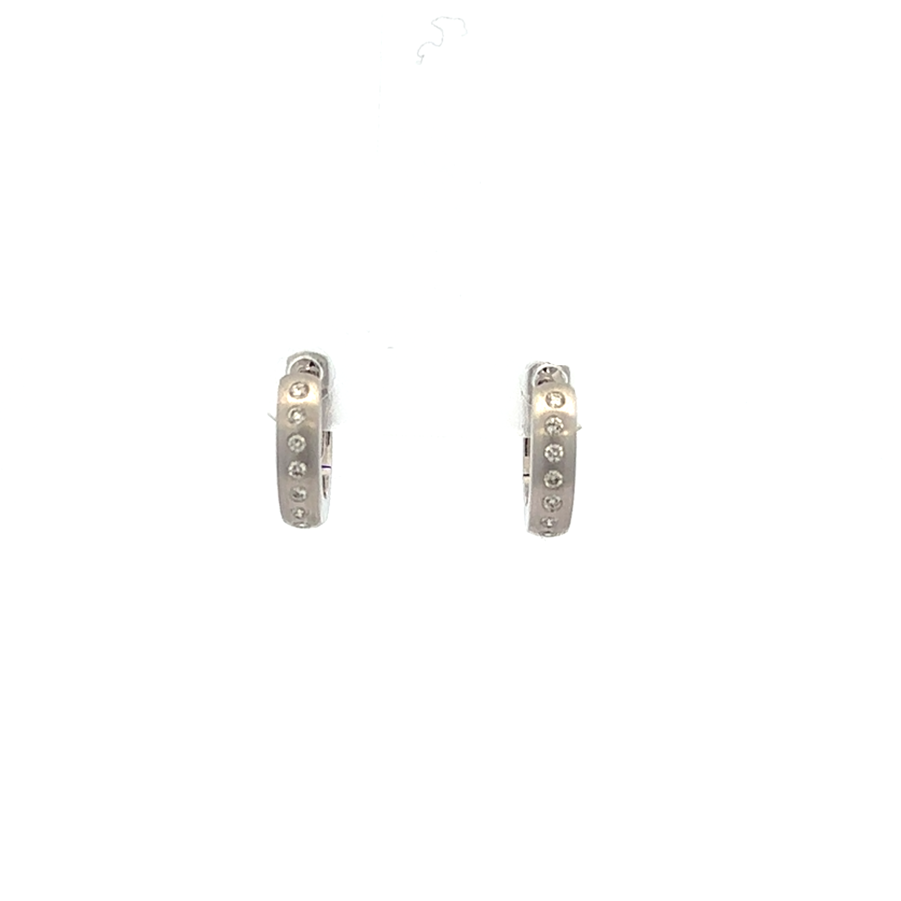Pair of white gold hoop earrings with small stones on a white background