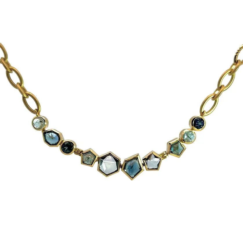 Necklace with gold chain and multicolored gemstones on a white background