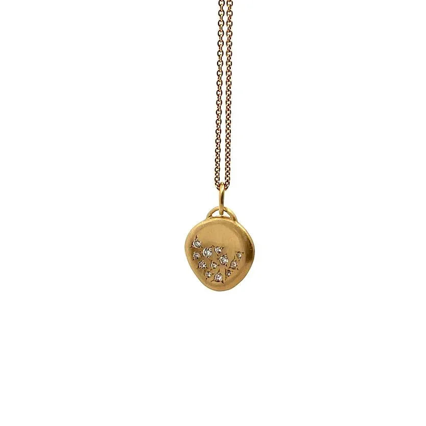 The Ali Dumont Gold and Diamond Half-Full Pendant is an 18k yellow gold necklace featuring a small, irregular pendant set with tiny round brilliant diamonds on a fine gold chain, shown against a white background.