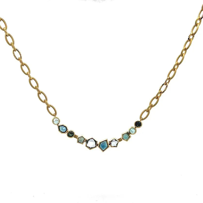 Gold necklace with gemstones on a white background