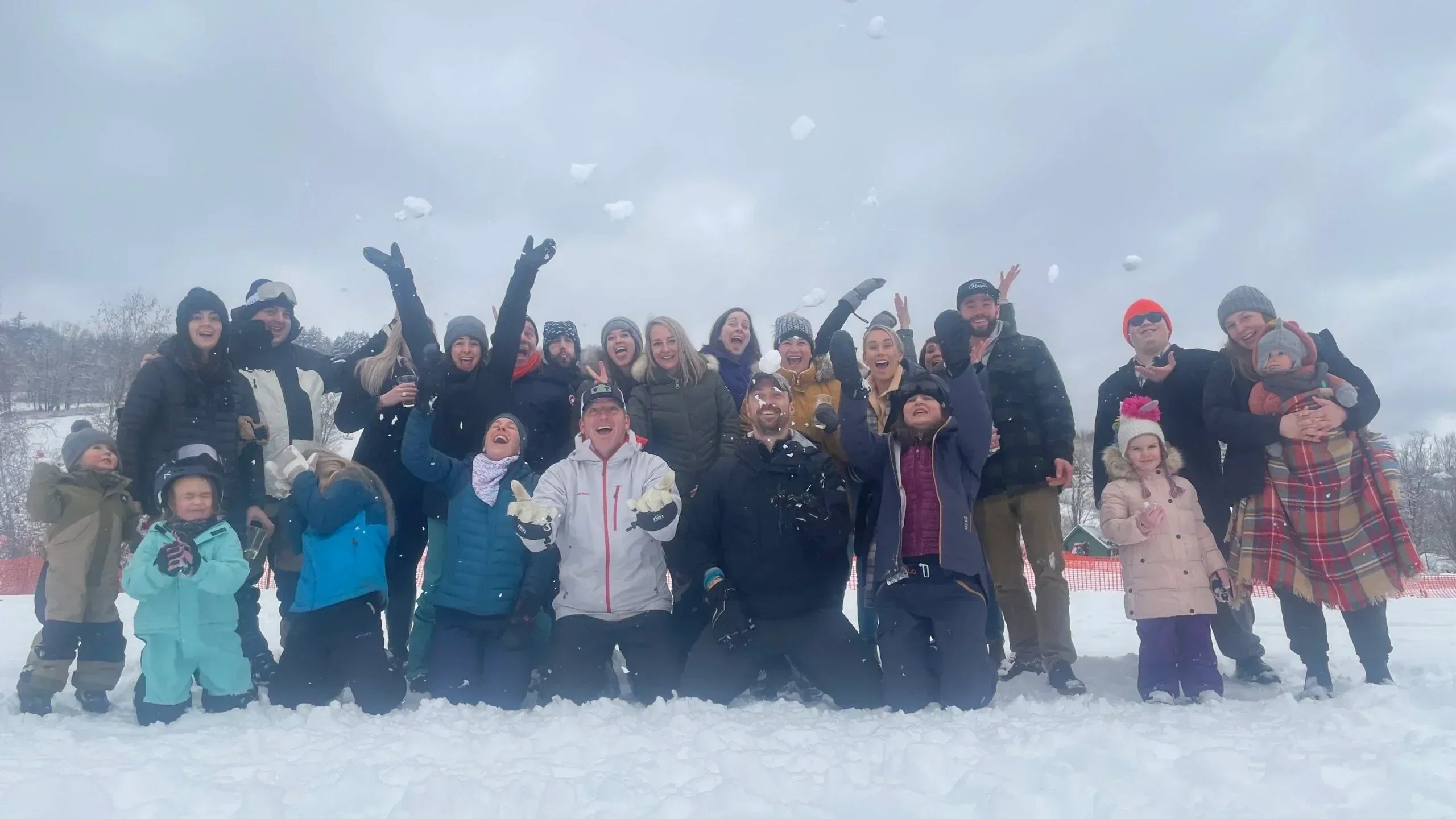 Group of people posing for a photo in the snow