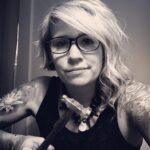 Person with long hair and glasses wearing a patterned shirt. Karen Ryer - Quechee Studio Manager