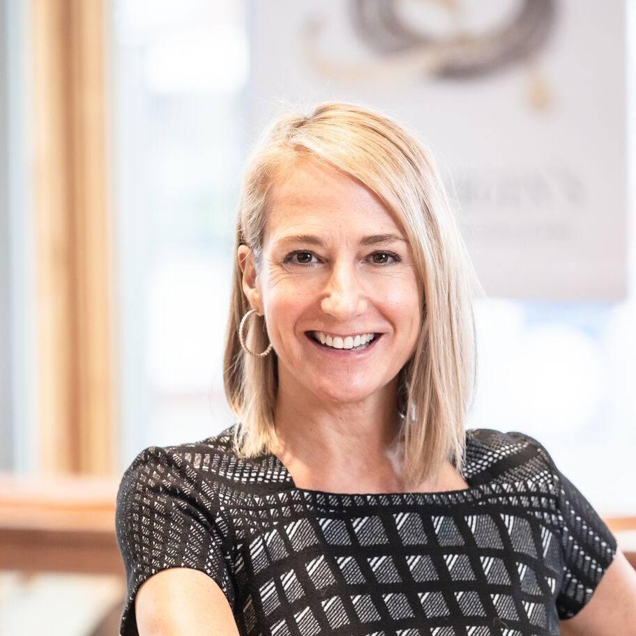 Woman with blonde hair smiling in an indoor setting