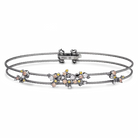 Multistrand bracelet with floral charm on a white background