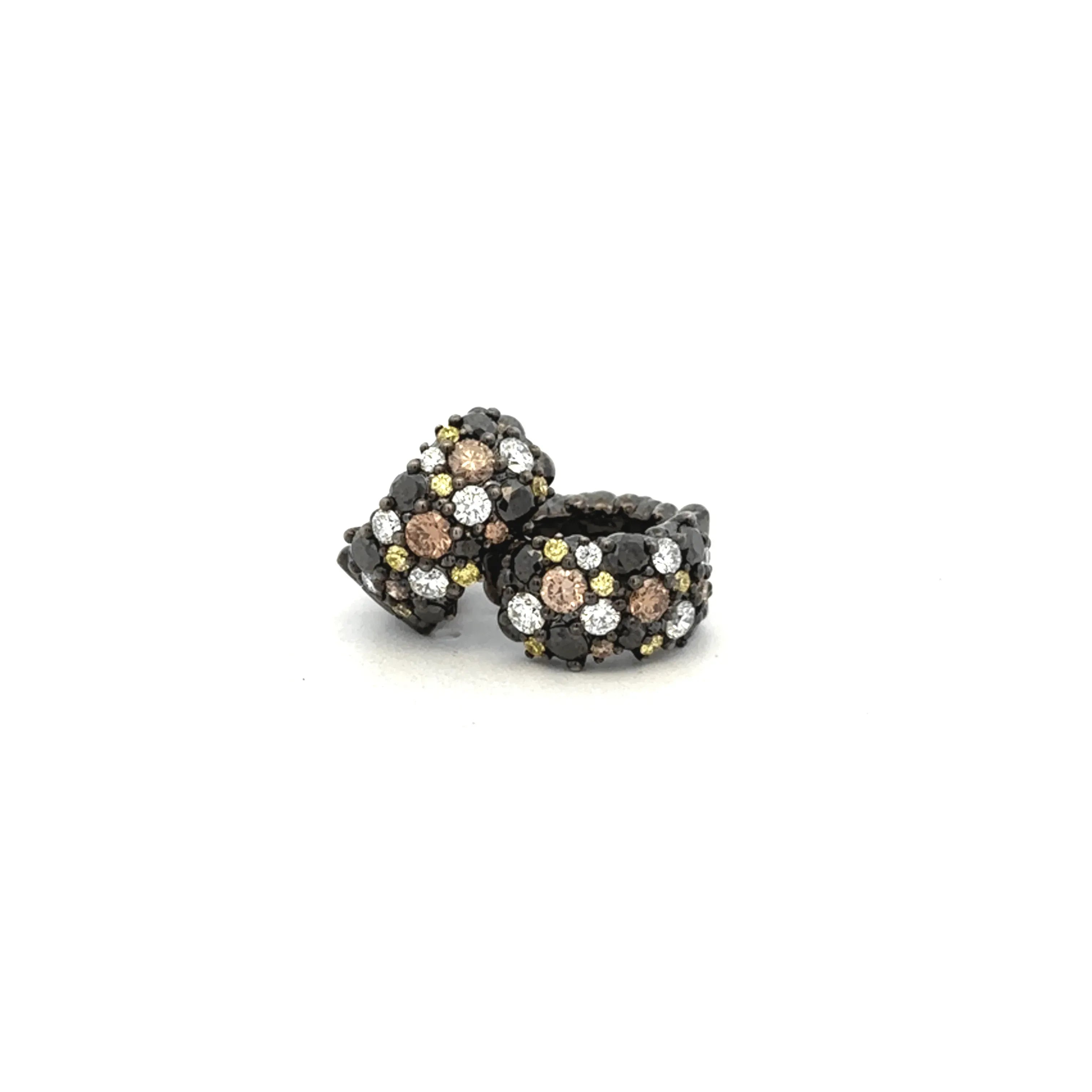 A pair of Multi-Color Diamond Confetti Huggie earrings in black rhodium plated white gold, featuring round diamonds in brown, white, and yellow, displayed on a plain white background.