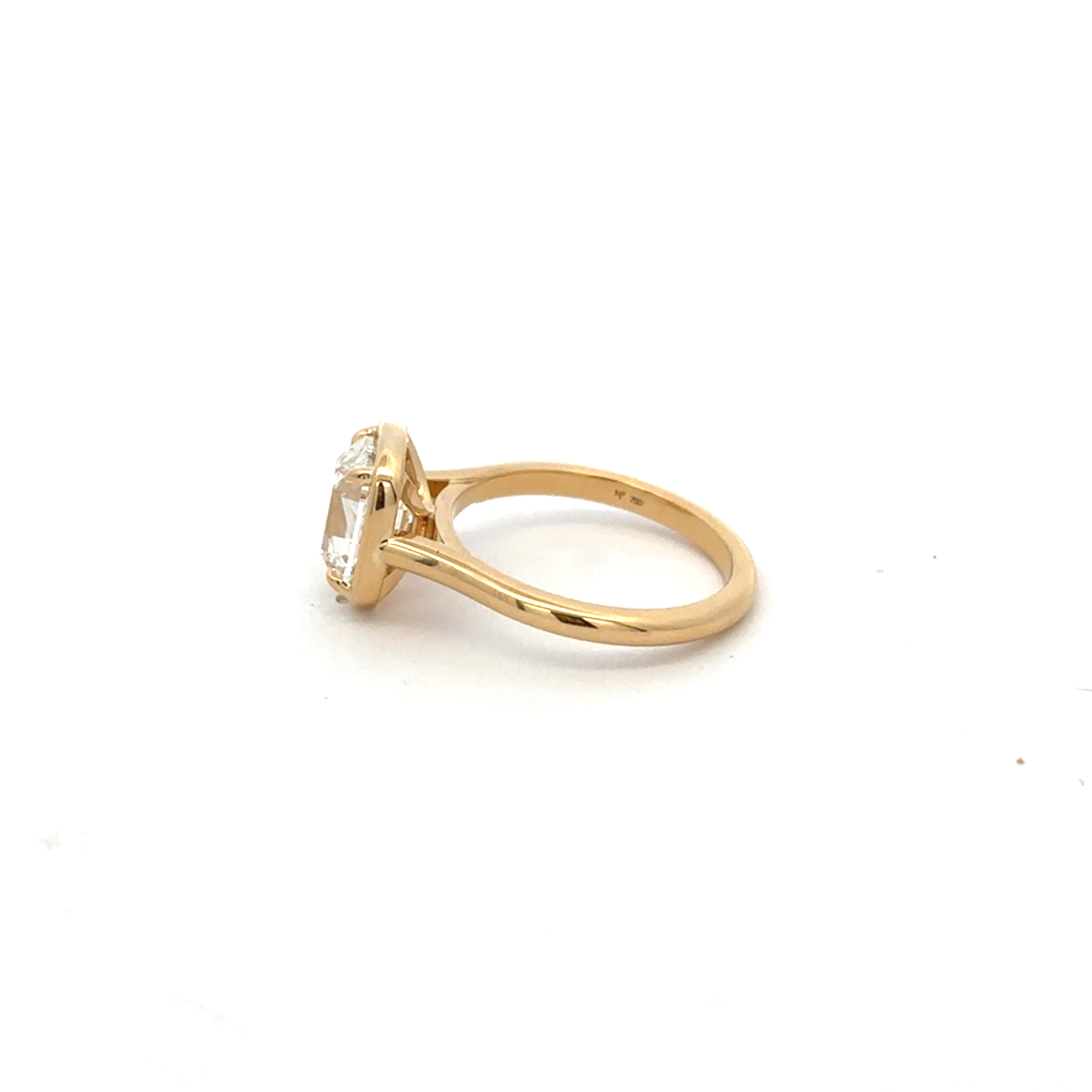 Gold ring with a diamond on a white background