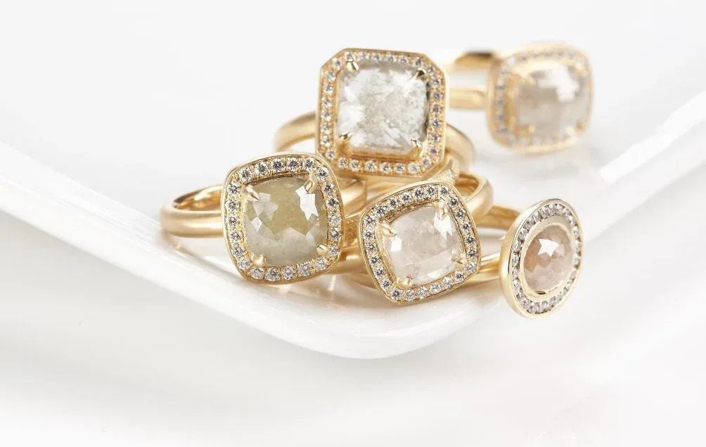 Gold rings with gemstones on a white surface