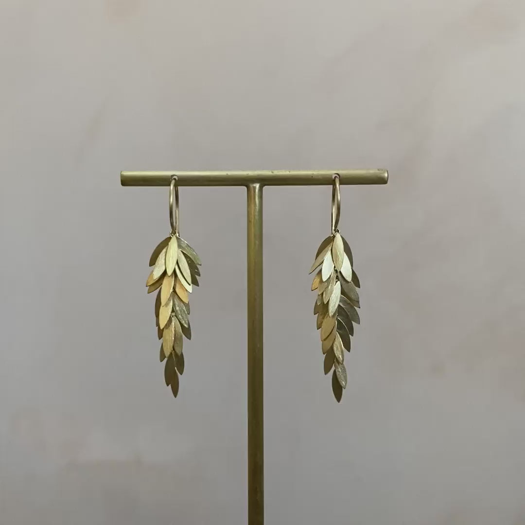 Video of Sia Taylor gold leaf dangle earrings.  Someone uses a metal rod to show how the gold leafs move.