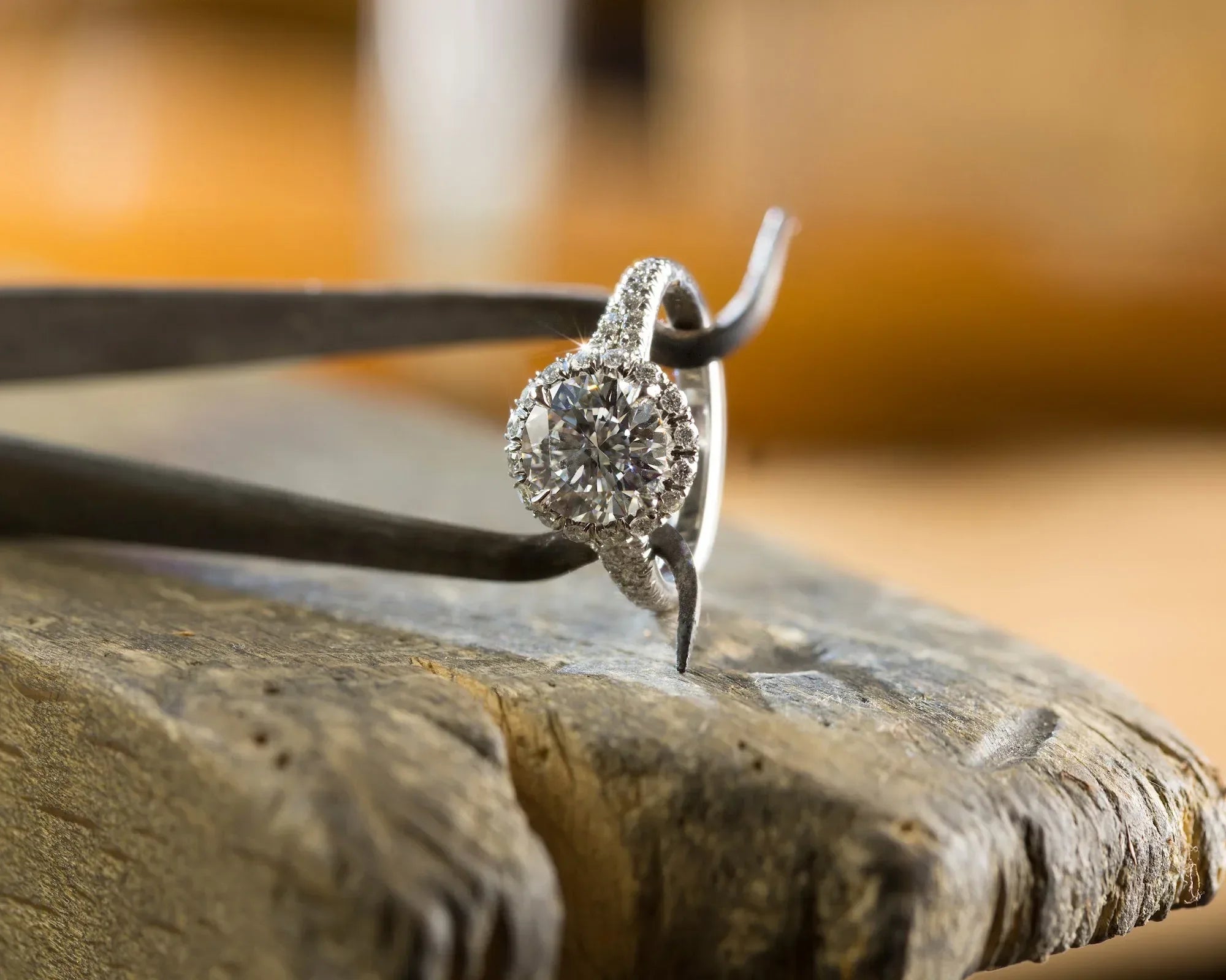 Silver ring with a diamond on a wooden surface